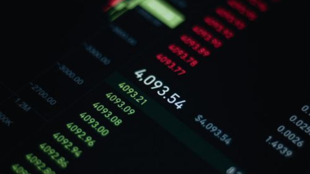 Close-up of stock market data with fluctuating numbers and graphs on screen.