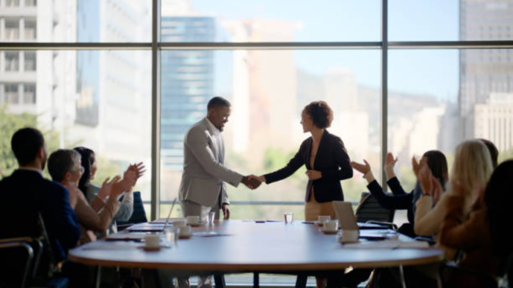 Meeting, handshake and business people in office for interview, welcome applause or onboarding for collaboration. 