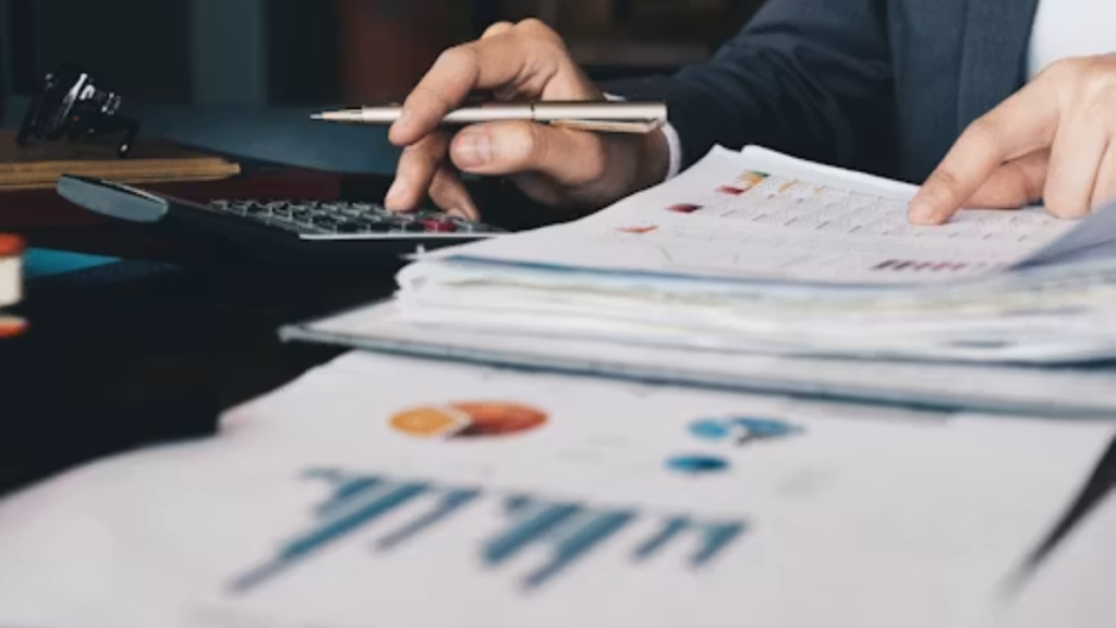 Businesswoman using a calculator to calculate numbers for a document